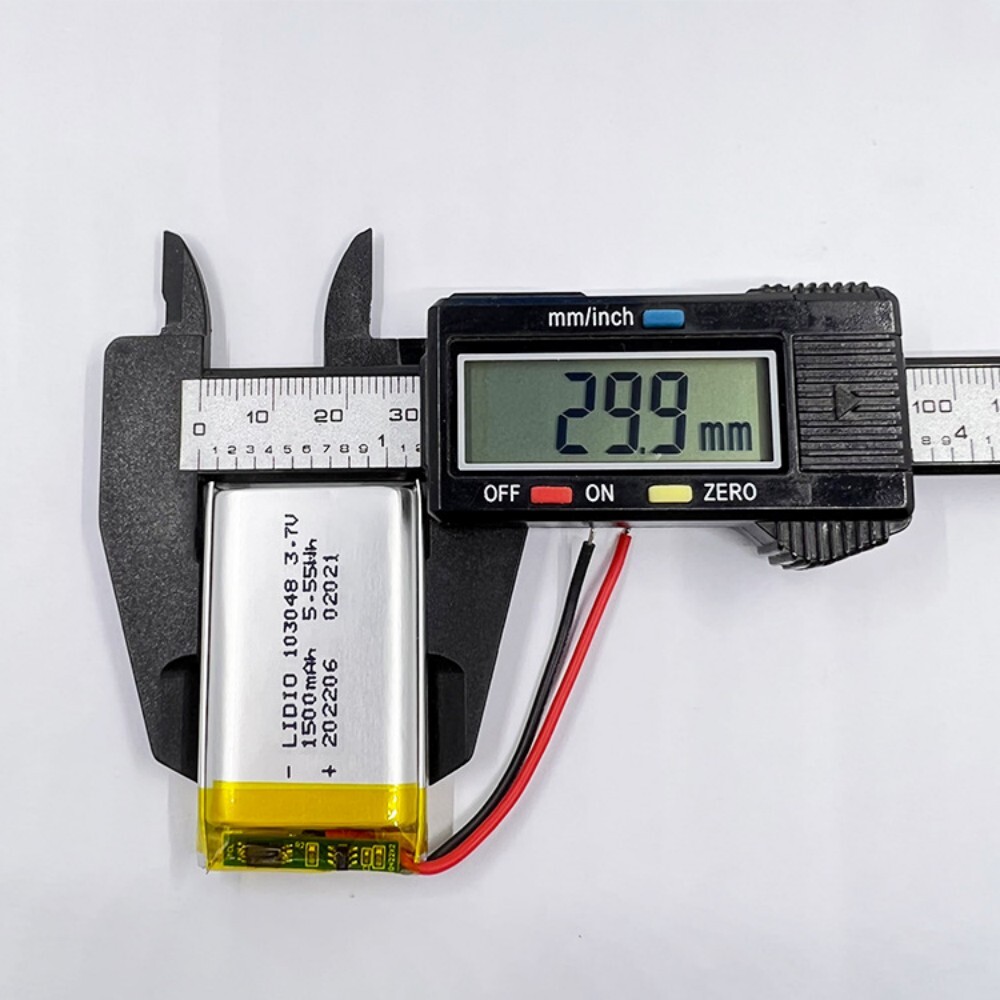 103048 battery width measurement, caliper showing 30mm, ensuring proper fit for device battery compartment