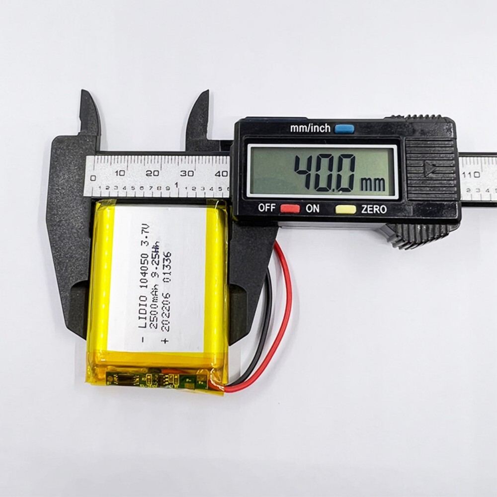 104050 battery width measurement, caliper showing 40mm, ensuring proper fit for device battery compartment