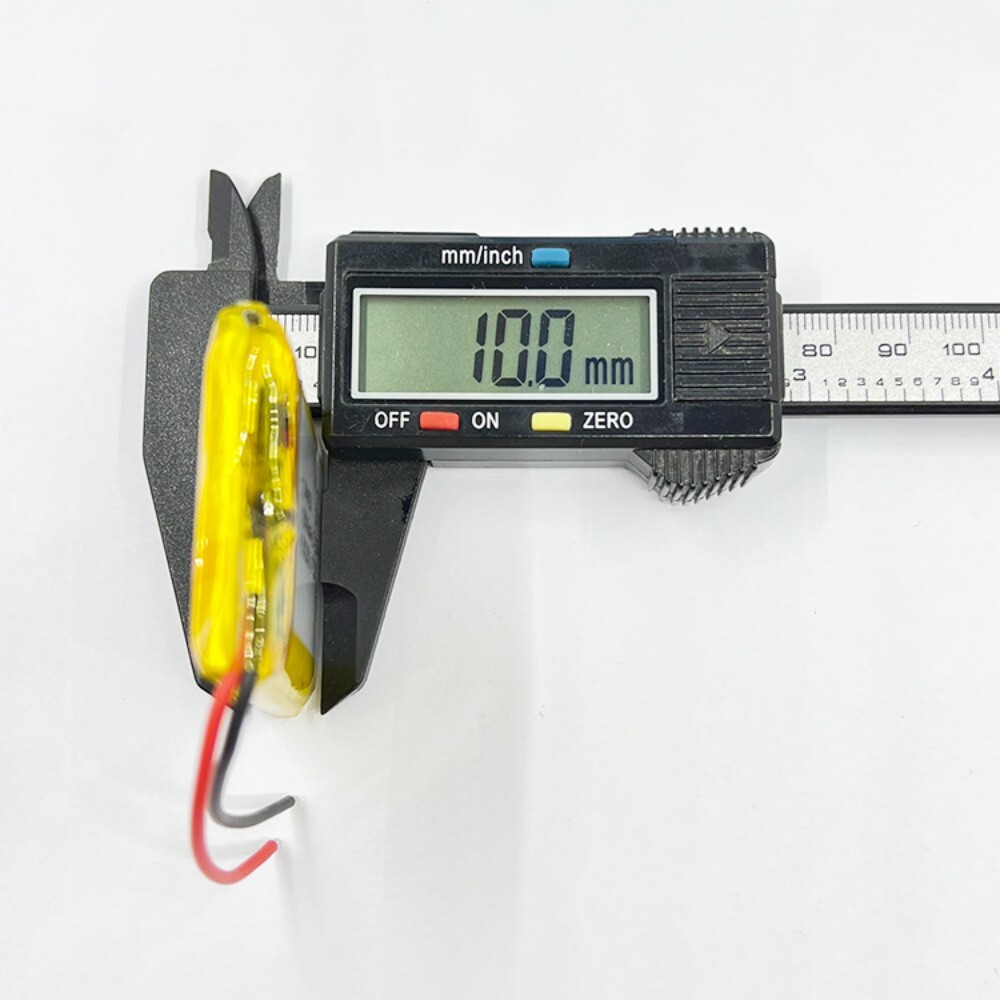 104050 battery thickness measurement, caliper showing 10mm, verifying size compatibility with portable electronics