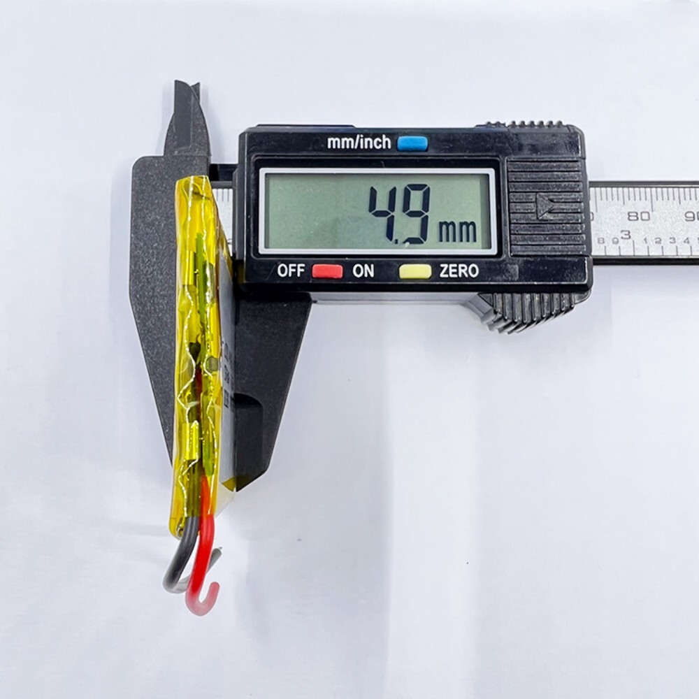494251 battery thickness measurement, caliper showing 4.9mm, verifying ultra-thin profile for compact devices