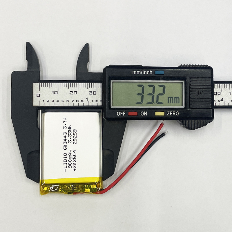 603443 battery width measurement, caliper showing 34mm, ensuring proper fit for device battery compartment